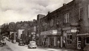 Spruce Pine’s first theater was not the Carolina. The Piedmont Theatre, which was originally located on Lower Street where Dellinger’s Christian Bookstore is today, was opened in 1928 by John Taylor. The theater originally hosted silent movies and featured a large pump organ that provided musical accompaniment. It later switched to “talkies” and served as a stage for dance and music recitals. The Piedmont also hosted fundraisers for the Spruce Pine Band when it traveled to the state competition in Greensboro. On January 1, 1938, the Piedmont closed when its equipment and contracts were purchased by the Cherokee Amusement Company, which had opened the Carolina Theatre just before Christmas in 1937. As part of the sale, Taylor agreed to shutter the business and not operate a playhouse in the vicinity for a period of 10 years. There were several times when folks in Spruce Pine had two theaters to choose from. The Baker Theater on Oak Avenue provided the latest Hollywood films as well. This photo was made in the 1930s, when the Piedmont still had a presence on Lower Street.