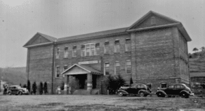 In 1959 , the 30th anniversary of the first graduating class, the old Tipton Hill High School was torn down to make room for the new lunchroom and gym. This building, which was dated May 18, 1921, was funded by the Methodist church and a bible was placed within its walls. This bible was found in 1959 when the building was torn down. Enough funds could not be raised to complete the building so the Mitchell County Board of Education purchased the property on August 26, 1924. By 1927, three years of instruction could be obtained at Tipton Hill High School. Tipton Hill began as a four year High school in 1928. Mr. Yelton was the principal and Mrs. Yelton and Mr. L. R. Vann were the faculty. Seven students graduated that year. In 1930 the High School was accredited by the State Department.