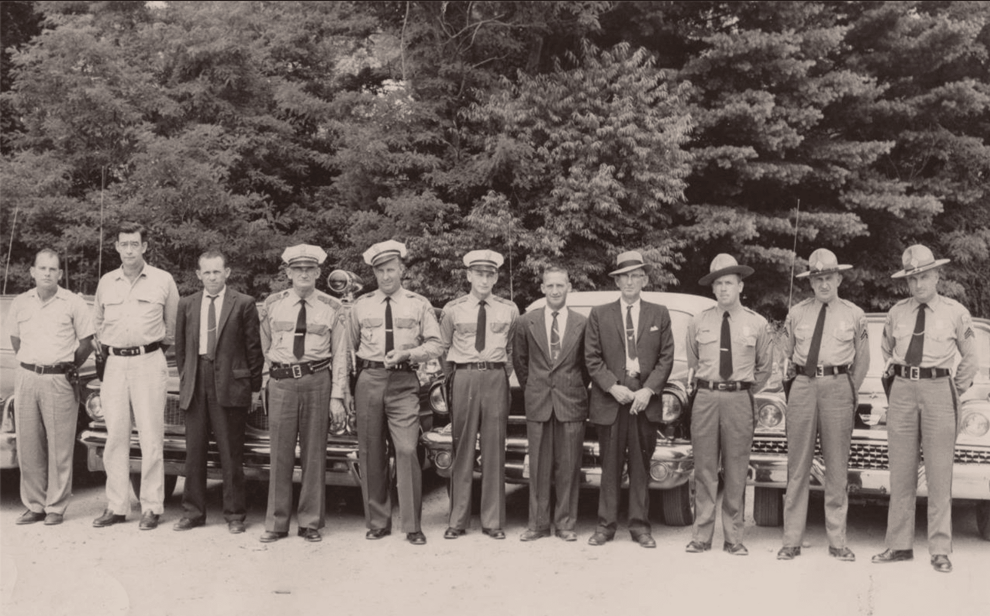 Mitchell County’s law enforcement community poses for this picture circa 1960. Left to right are: James Edwards, Mitchell County Deputy, Joe Stewart, Mitchell County Deputy, Sam Gouge, Mitchell County Sheriff, Jim Burleson, Chief of Police, Ray Gunter, Spruce Pine Police, Cotton Burleson, Spruce Pine Police, Herb Teague, Detective Spruce Pine, Zeke Howell, Mitchell County Jailer, Charlie Radcliffe, NC Highway Patrolman, R. E. Pipes, NC Highway Patrolman, Lee Lance, NC Highway Patrolman.