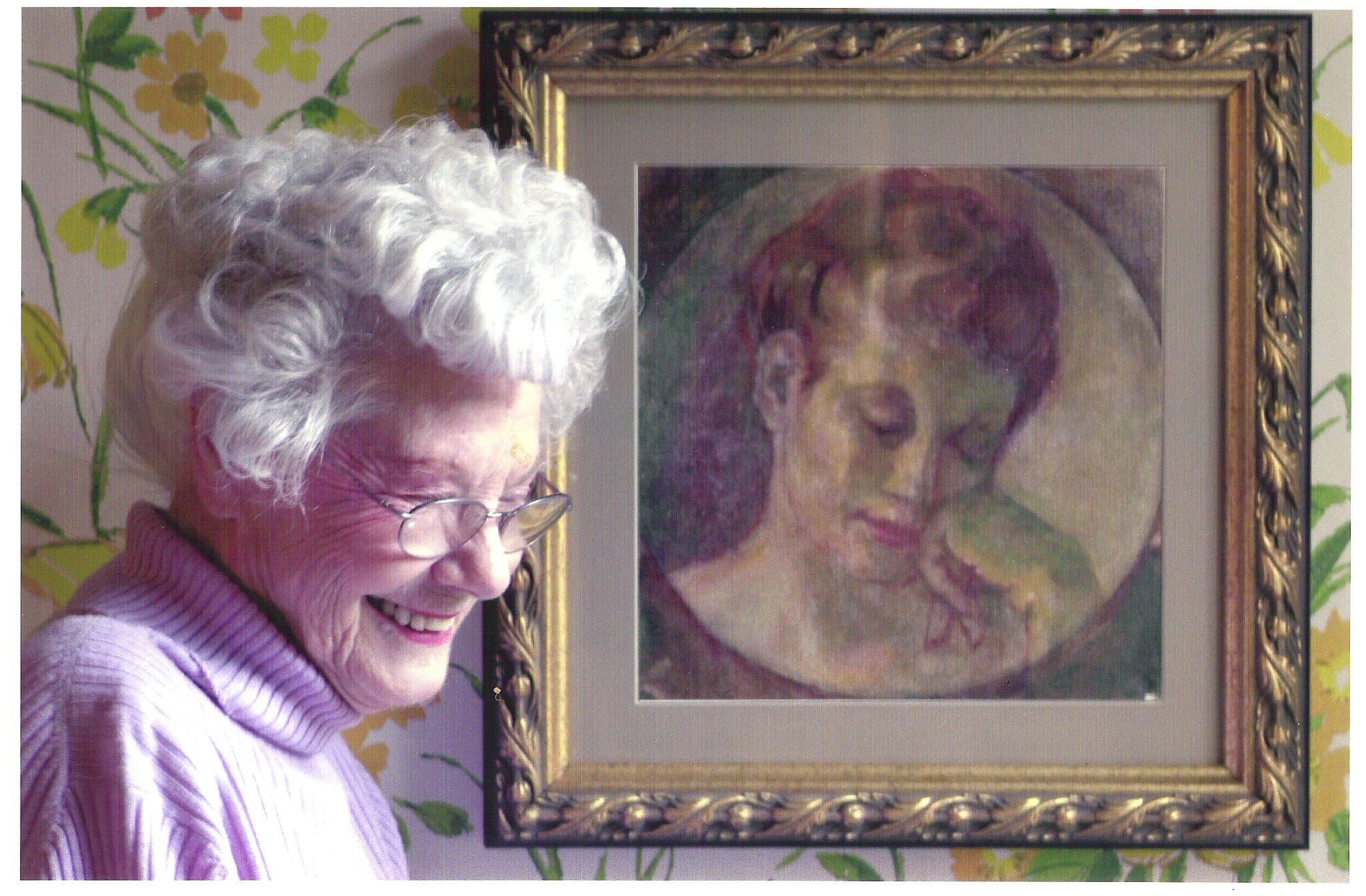 Aunt Mickey standing in front of a portrait of her reading a book, by her husband, Paul W. Whitener, who passed away in 1959, 23 years after their marriage in 1936.
